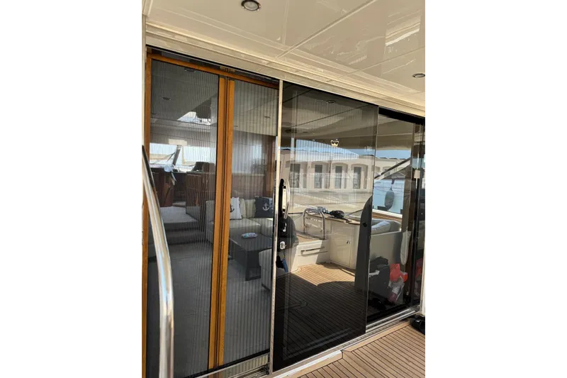  Yacht Photos Pics Luxurious 2012 Princess 60 yacht interior with sliding glass doors and elegant furnishings.