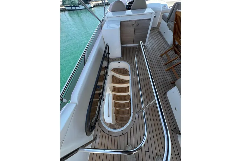  Yacht Photos Pics Luxurious 2012 Princess 60 yacht deck with wooden flooring and sleek railing.