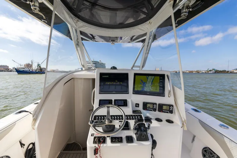 Fools Gold Yacht Photos Pics 2017 Contender 39 Fish Around boat cockpit with navigation screens and steering wheel.