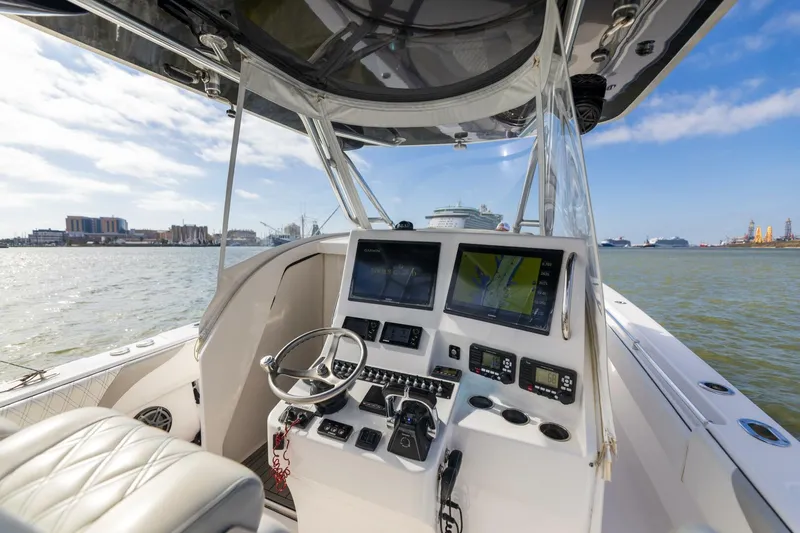 Fools Gold Yacht Photos Pics 2017 Contender 39 Fish Around boat cockpit with navigation controls on open water.