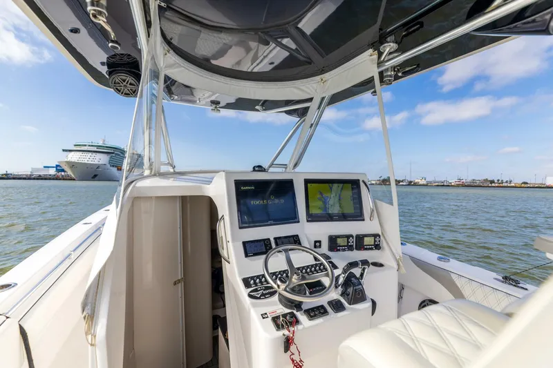 Fools Gold Yacht Photos Pics 2017 Contender 39 Fish Around boat cockpit with navigation screens and steering wheel.