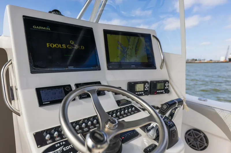 Fools Gold Yacht Photos Pics Control panel of 2017 Contender 39 Fish Around boat with navigation screens.