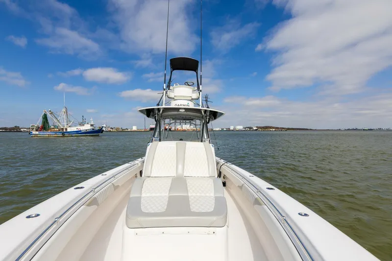 Fools Gold Yacht Photos Pics 2017 Contender 39 Fish Around boat on calm water under blue sky.