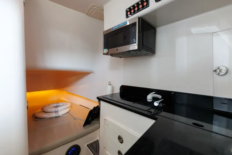 Fools Gold Yacht Photos Pics 2017 Contender 39 Fish Around cabin interior with microwave and cozy sleeping area.