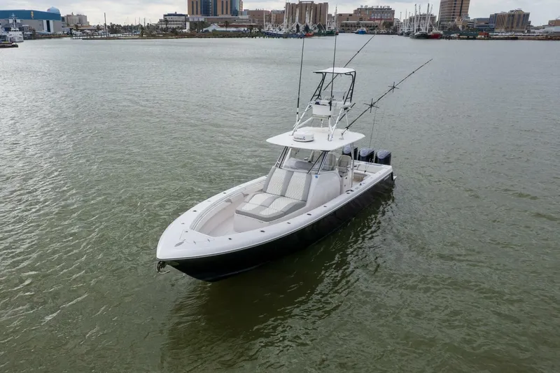 Fools Gold Yacht Photos Pics 2017 Contender 39 Fish Around boat on calm water, cityscape in background.