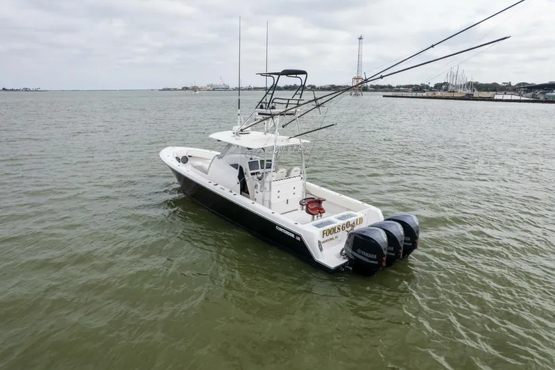 Fools Gold Yacht Photos Pics 2017 Contender 39 Fish Around boat on calm water with fishing rods.