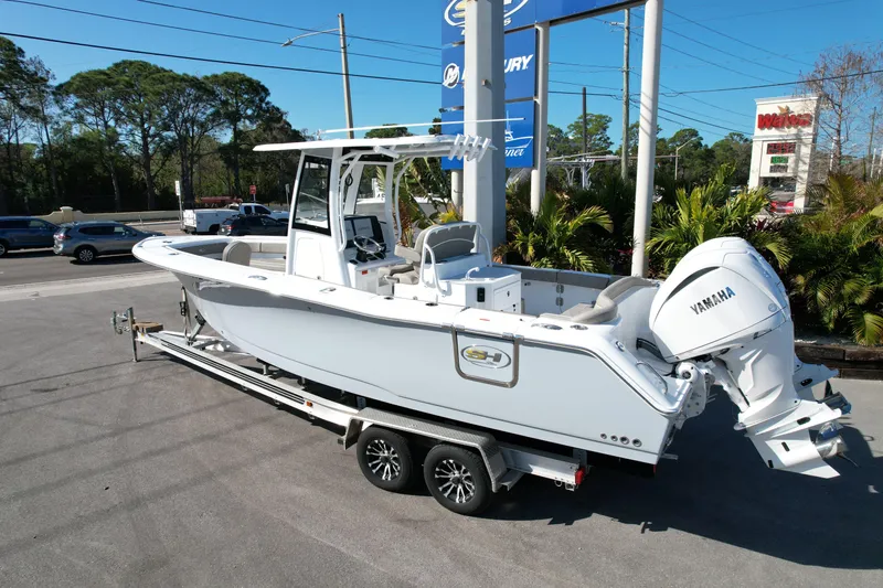 Yacht Photos Pics 2025 Sea Hunt Ultra 275 SE boat on trailer, featuring Yamaha engine, parked outdoors.