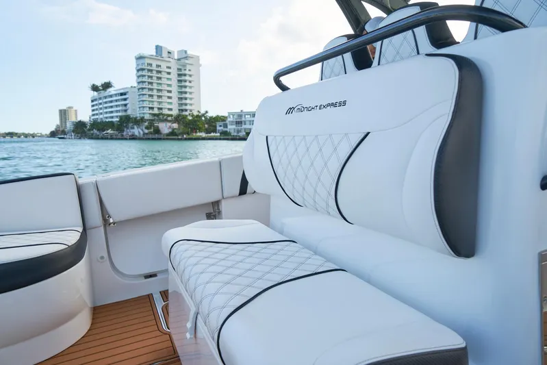  Yacht Photos Pics 2020 Midnight Express 37' Open boat interior with white seating, waterfront view.