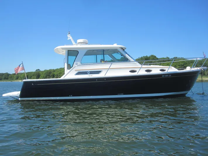  Yacht Photos Pics 2014 Back Cove 34 Hard Top boat on calm water, side view.