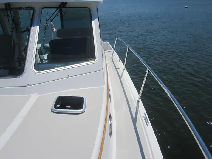  Yacht Photos Pics 2014 Back Cove 34 Hard Top boat on water, featuring sleek deck and railing.