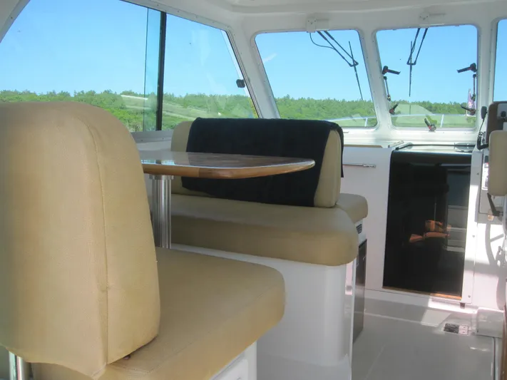  Yacht Photos Pics Interior of 2014 Back Cove 34 Hard Top boat with beige seating and table.