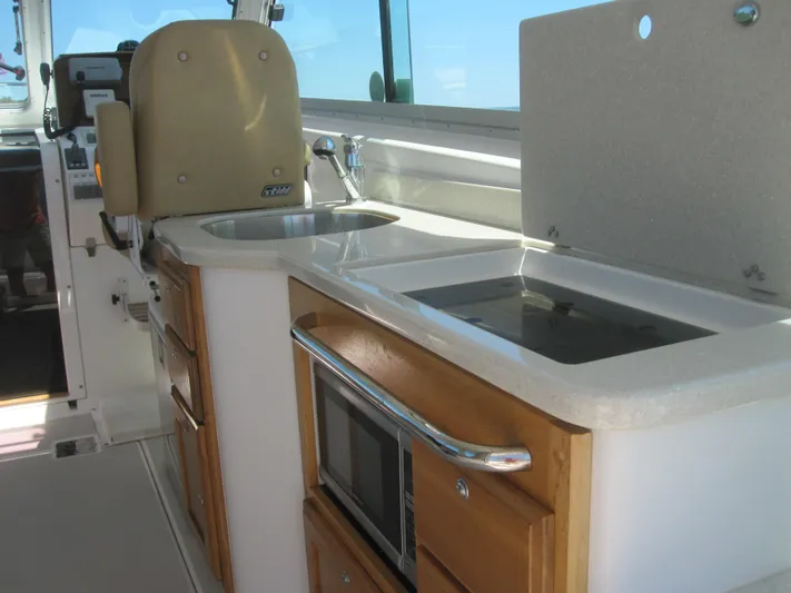  Yacht Photos Pics 2014 Back Cove 34 Hard Top interior with kitchenette, sink, and microwave.