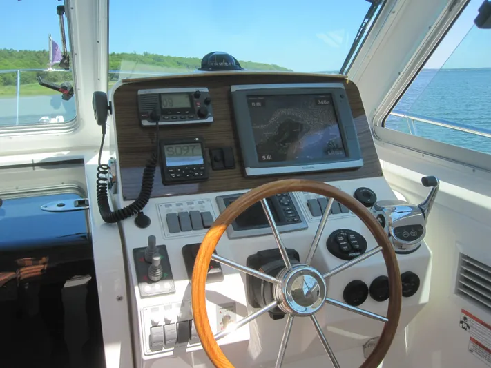  Yacht Photos Pics 2014 Back Cove 34 Hard Top helm with steering wheel and navigation equipment.