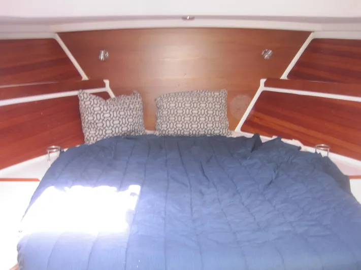  Yacht Photos Pics Cozy cabin interior of 2014 Back Cove 34 with blue bedding and patterned pillows.