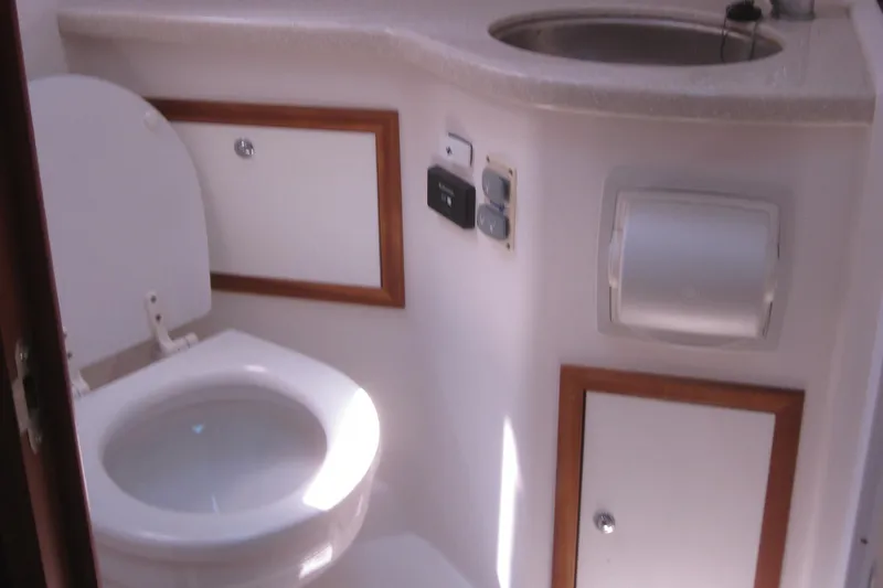  Yacht Photos Pics 2014 Back Cove 34 yacht bathroom with toilet, sink, and storage cabinets.