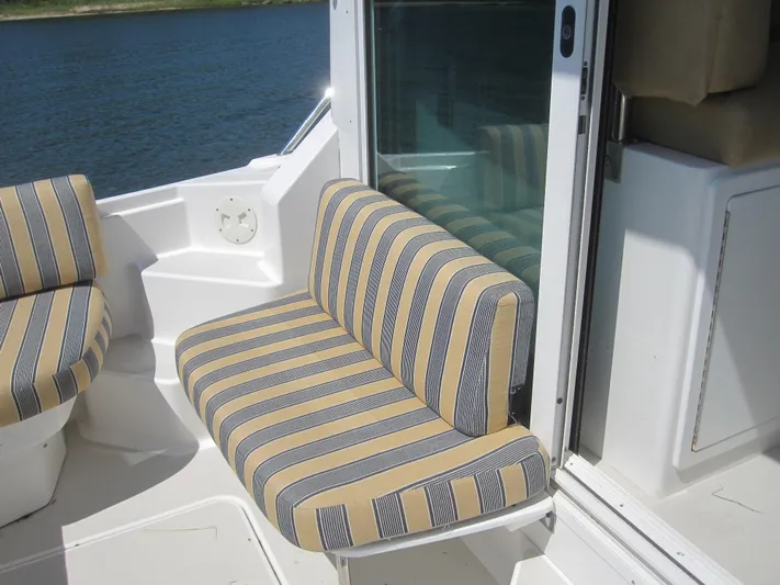  Yacht Photos Pics Striped seating on 2014 Back Cove 34 Hard Top boat, near water.