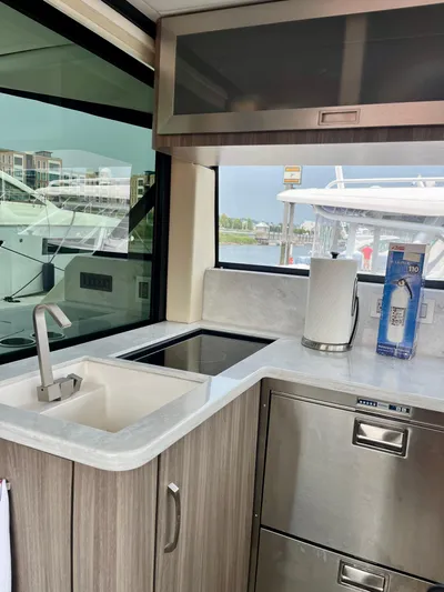  Yacht Photos Pics Modern kitchen area in 2022 Regal 38 XO yacht with sink and appliances.