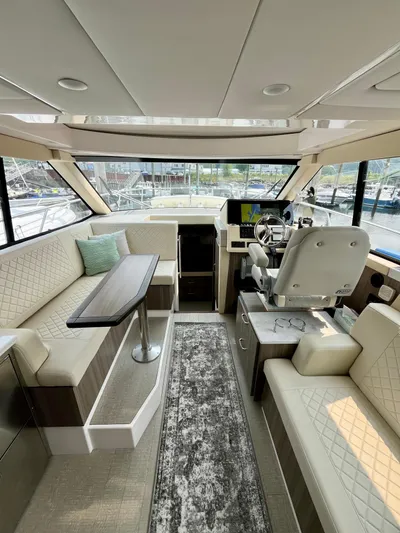  Yacht Photos Pics Luxurious interior of 2022 Regal 38 XO yacht with plush seating and modern helm.