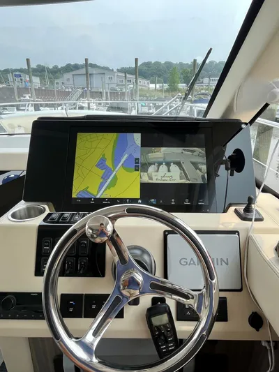  Yacht Photos Pics Helm of 2022 Regal 38 XO yacht with Garmin navigation display and steering wheel.