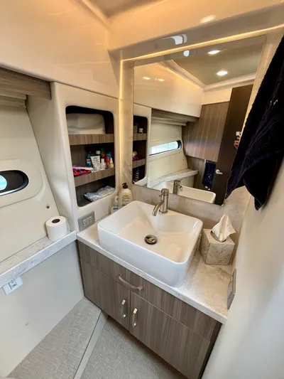  Yacht Photos Pics Luxurious bathroom interior of 2022 Regal 38 XO yacht with modern sink and storage.