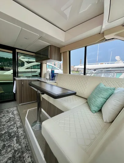  Yacht Photos Pics Interior of 2022 Regal 38 XO yacht with modern seating and table.