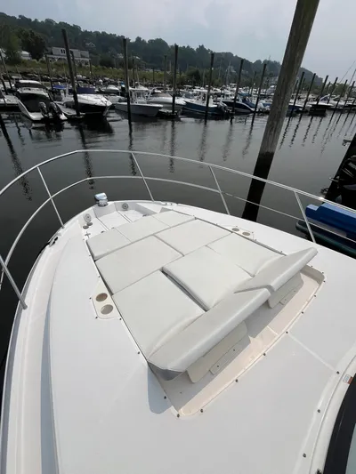  Yacht Photos Pics Bow view of 2022 Regal 38 XO yacht with sunpad, docked in marina.