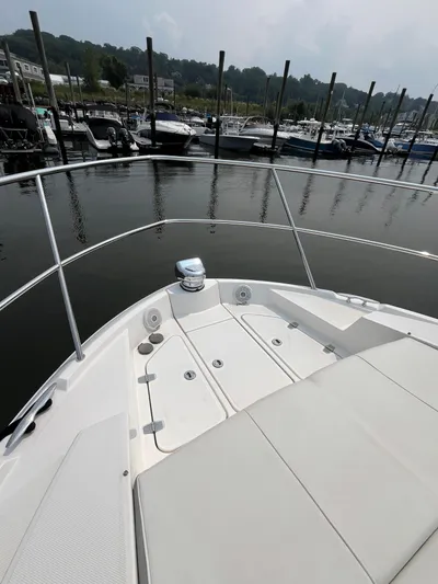  Yacht Photos Pics Bow of 2022 Regal 38 XO yacht docked at marina, featuring sleek design and spacious deck.