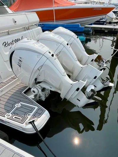  Yacht Photos Pics 2022 Regal 38 XO boat with triple outboard engines docked in marina.