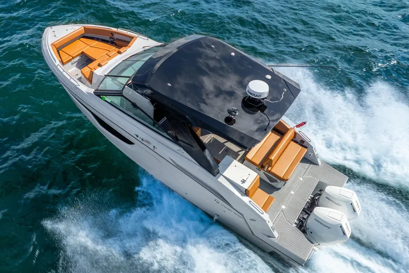 South Beach Edition -- Like New Trade In Yacht Photos Pics 2024 Cruisers Yachts 34 GLS OB speeding on open water, showcasing luxury and performance.