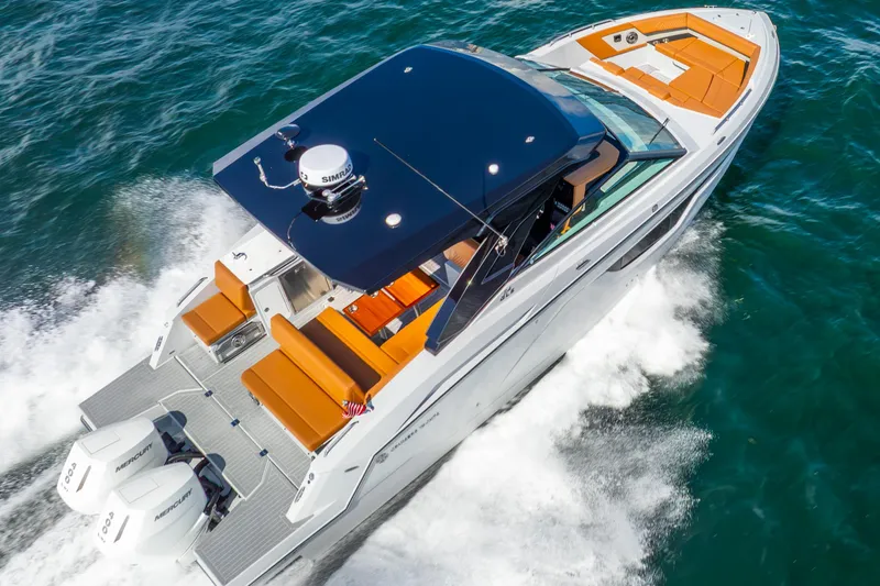 South Beach Edition -- Like New Trade In Yacht Photos Pics 2024 Cruisers Yachts 34 GLS OB cruising on open water, showcasing sleek design and powerful engines.