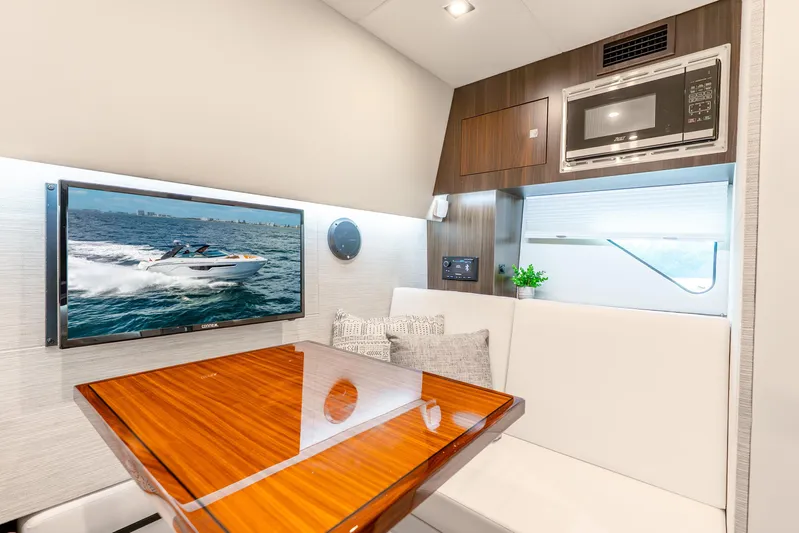 South Beach Edition -- Like New Trade In Yacht Photos Pics 2024 Cruisers Yachts 34 GLS OB interior with TV, microwave, and elegant seating area.