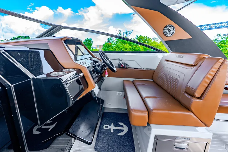 South Beach Edition -- Like New Trade In Yacht Photos Pics 2024 Cruisers Yachts 34 GLS OB interior with brown leather seating and modern dashboard.