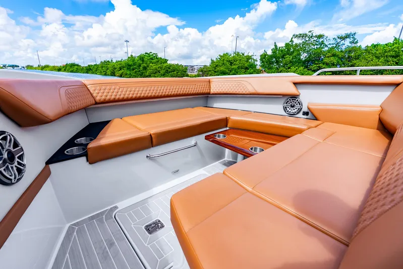 South Beach Edition -- Like New Trade In Yacht Photos Pics Luxurious seating area on 2024 Cruisers Yachts 34 GLS OB, featuring tan upholstery and cup holders.