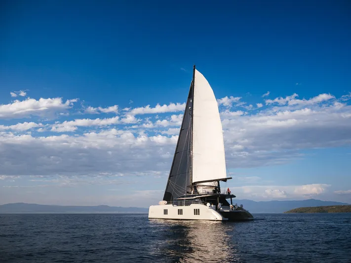 N+1 Yacht Photos Pics 2024 Sunreef 70 Eco sailing yacht on open sea under clear blue sky.