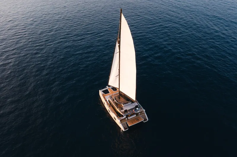 N+1 Yacht Photos Pics Aerial view of 2024 Sunreef 70 Eco yacht sailing on open water.