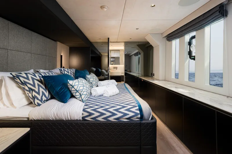 N+1 Yacht Photos Pics Luxurious bedroom interior of 2024 Sunreef 70 Eco yacht with ocean view.