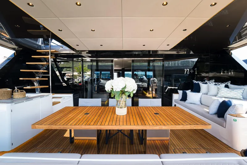 N+1 Yacht Photos Pics Luxurious Sunreef 70 Eco yacht interior with elegant wooden table and plush seating, 2024 model.