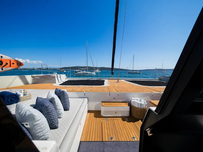 N+1 Yacht Photos Pics Luxurious Sunreef 70 Eco yacht deck with cushions, ocean view, and clear blue sky, 2024 model.