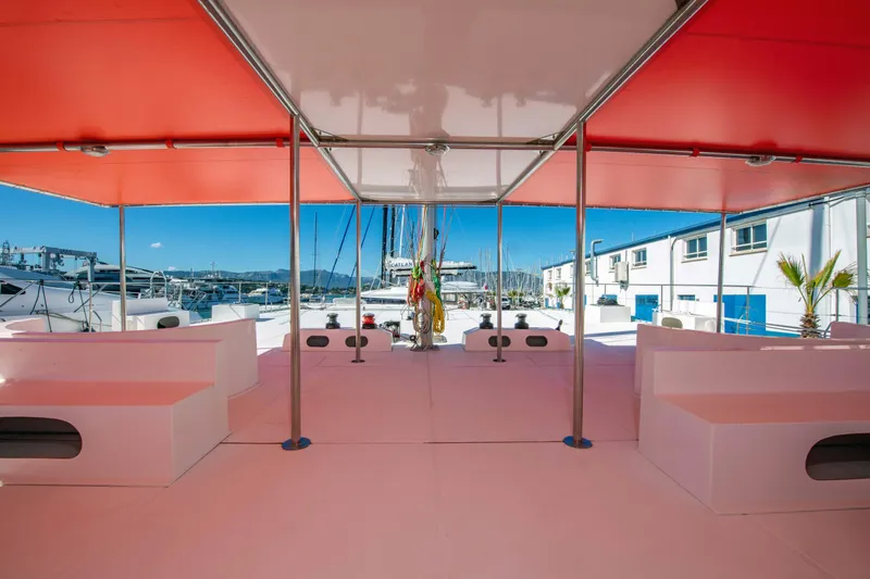  Yacht Photos Pics Spacious deck of 2026 Custom DAYCHARTER boat with red canopy and marina view.