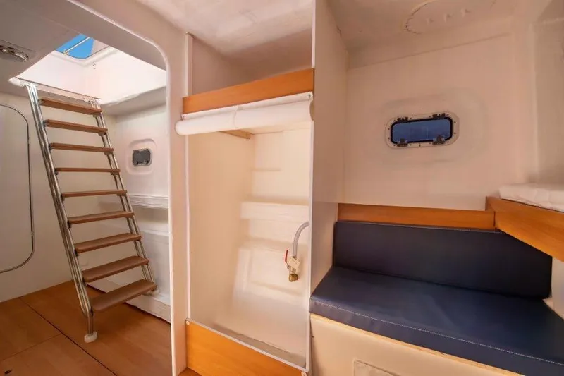  Yacht Photos Pics Interior of 2026 Custom DAYCHARTER boat with wooden stairs and seating area.