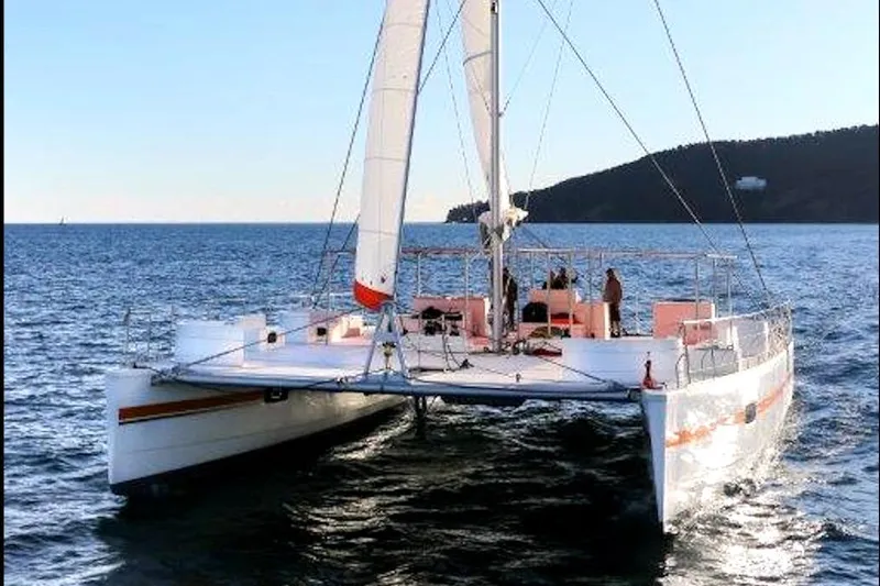 Yacht Photos Pics Custom DAYCHARTER 2026 catamaran sailing on open sea with clear sky.