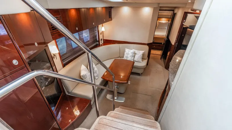 Three Sons Yacht Photos Pics Luxurious interior of 2008 Sea Ray Sundancer yacht with elegant seating and wooden finishes.