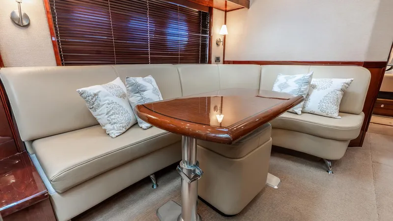 Three Sons Yacht Photos Pics Luxurious interior of 2008 Sea Ray Sundancer with elegant seating and wooden table.