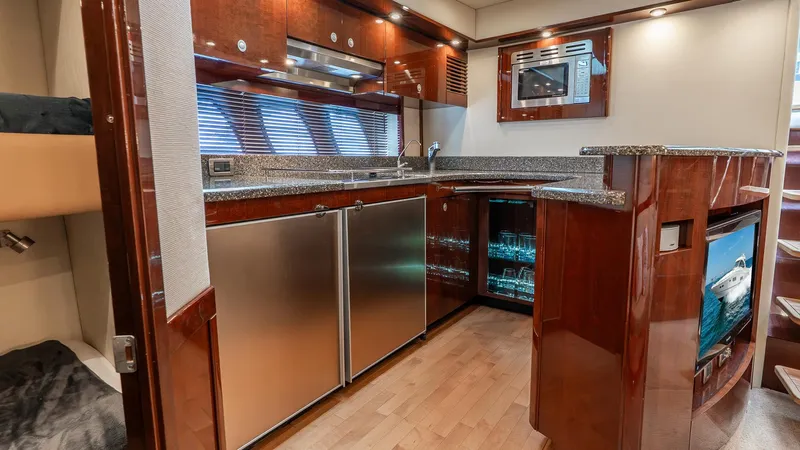 Three Sons Yacht Photos Pics Luxurious 2008 Sea Ray Sundancer yacht interior with modern kitchen and wood finishes.