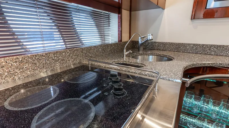 Three Sons Yacht Photos Pics Luxurious 2008 Sea Ray Sundancer yacht kitchen with modern stovetop and sleek countertops.