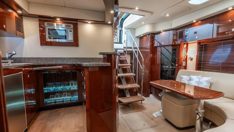 Three Sons Yacht Photos Pics Luxurious interior of a 2008 Sea Ray Sundancer yacht with modern kitchen and seating area.