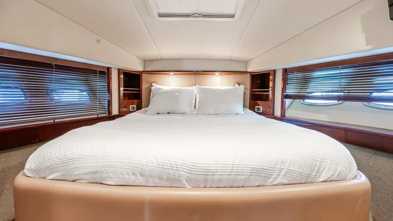 Three Sons Yacht Photos Pics Luxurious bedroom interior of 2008 Sea Ray Sundancer yacht with elegant bedding and wood accents.