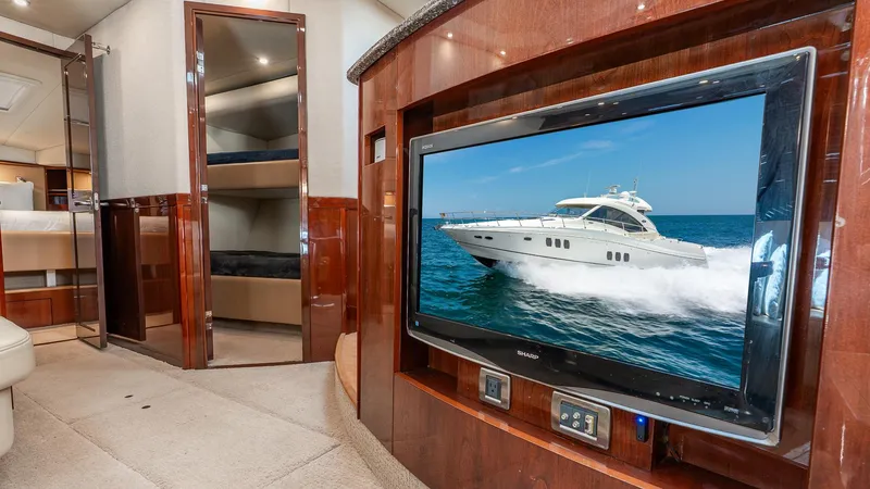 Three Sons Yacht Photos Pics Luxurious interior of 2008 Sea Ray Sundancer yacht with TV and wood paneling.