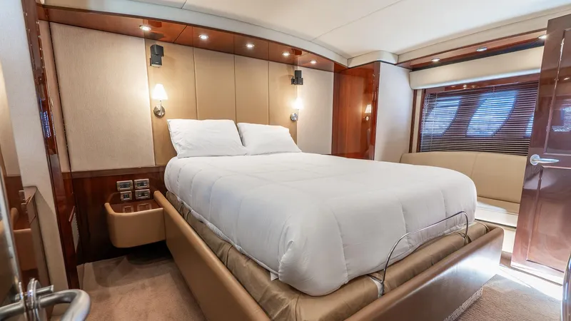Three Sons Yacht Photos Pics Luxurious bedroom interior of 2008 Sea Ray Sundancer yacht with elegant wood finishes.
