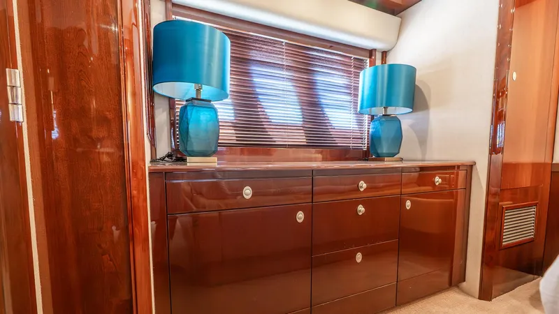 Three Sons Yacht Photos Pics Luxurious interior of 2008 Sea Ray Sundancer with elegant wood cabinetry and blue lamps.